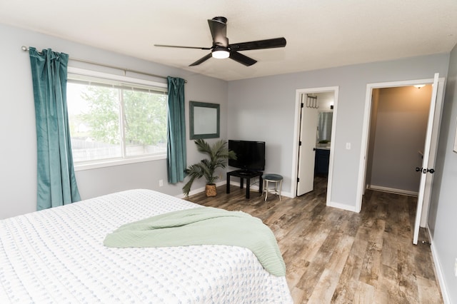 11748 Cloverview Dr, Ravenna, MI 49451 - bedroom featuring wood finished floors, baseboards, and a ceiling fan