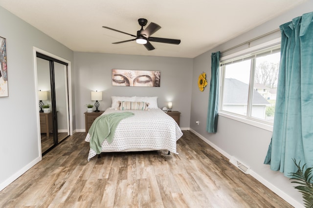 11748 Cloverview Dr, Ravenna, MI 49451 - bedroom with wood finished floors, baseboards, and a ceiling fan