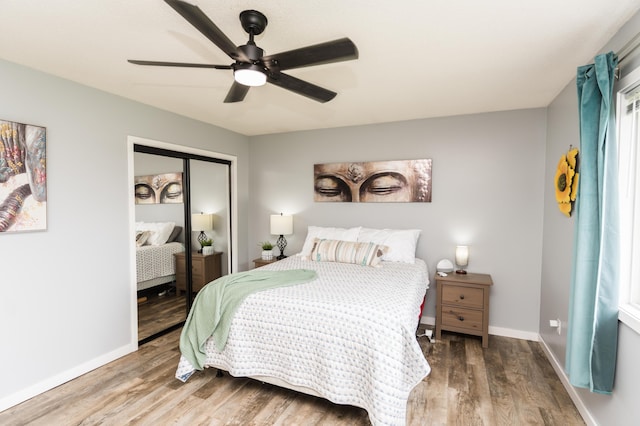 11748 Cloverview Dr, Ravenna, MI 49451 - bedroom featuring wood finished floors, a closet, baseboards, and a ceiling fan
