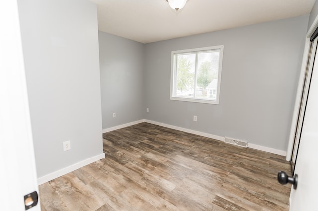 11748 Cloverview Dr, Ravenna, MI 49451 - unfurnished bedroom featuring wood finished floors and baseboards