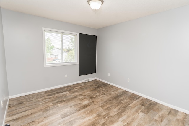 11748 Cloverview Dr, Ravenna, MI 49451 - unfurnished room with wood finished floors and baseboards