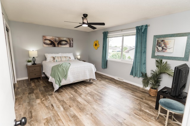 11748 Cloverview Dr, Ravenna, MI 49451 - bedroom featuring wood finished floors, baseboards, and a ceiling fan