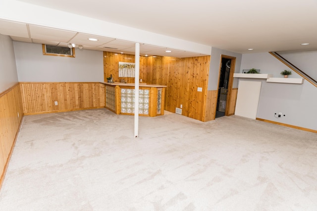 11748 Cloverview Dr, Ravenna, MI 49451 - finished below grade area featuring wooden walls, carpet, bar area, and a wainscoted wall