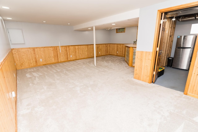 11748 Cloverview Dr, Ravenna, MI 49451 - finished basement featuring freestanding refrigerator, a wainscoted wall, wood walls, light carpet, and bar