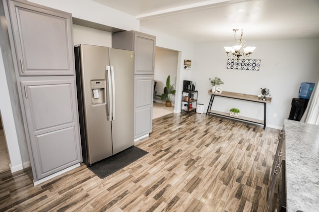 11748 Cloverview Dr, Ravenna, MI 49451 - kitchen featuring stainless steel refrigerator with ice dispenser, light wood-style floors, light countertops, and beam ceiling