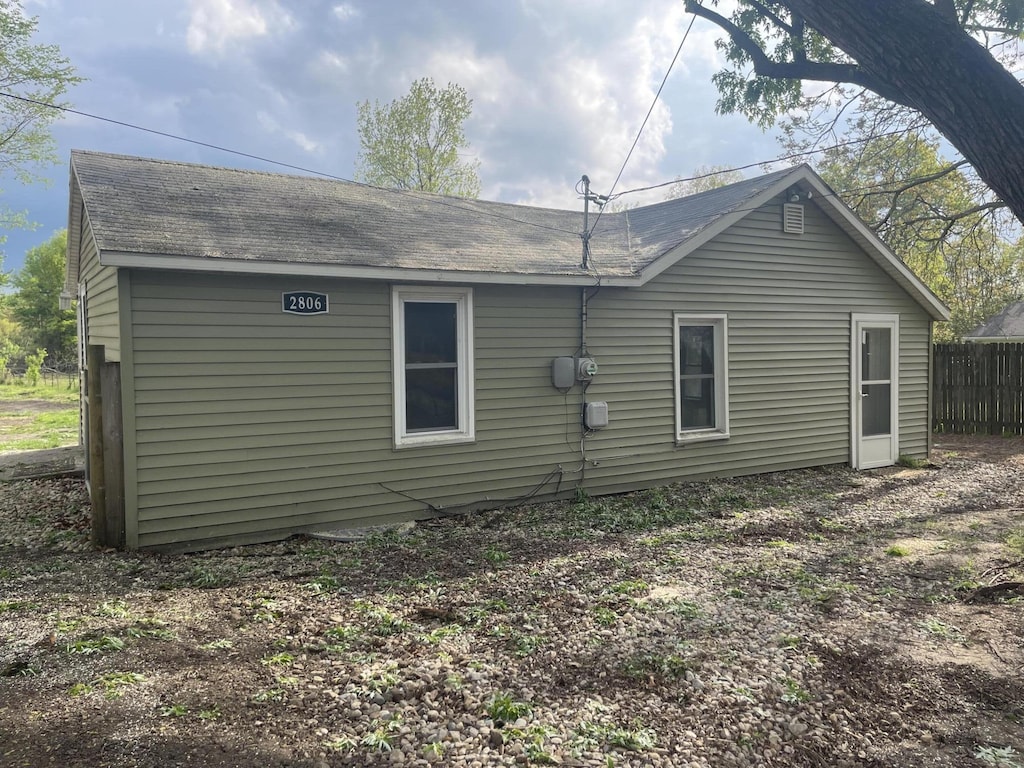 2806 Beebe Rd, Niles, MI 49120 - rear view of property featuring a shingled roof and fence