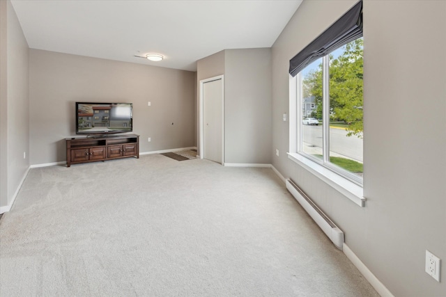 293 N 2nd St, Brighton, MI 48116 - unfurnished living room with a baseboard radiator, baseboards, and light colored carpet