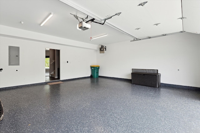 293 N 2nd St, Brighton, MI 48116 - garage featuring electric panel, a garage door opener, and baseboards