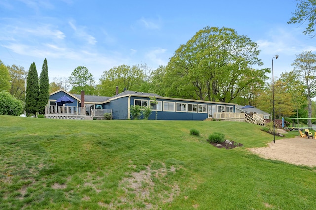 08763 Silver Lake Rd, Grand Junction, MI 49056 - back of house with a deck, a yard, and a chimney
