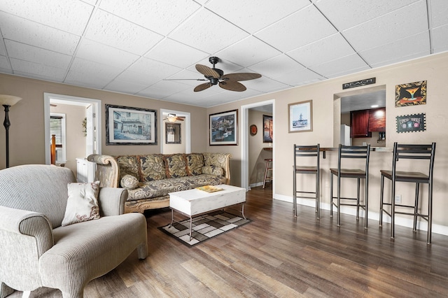 08763 Silver Lake Rd, Grand Junction, MI 49056 - living area with ceiling fan, wood finished floors, a drop ceiling, and baseboards