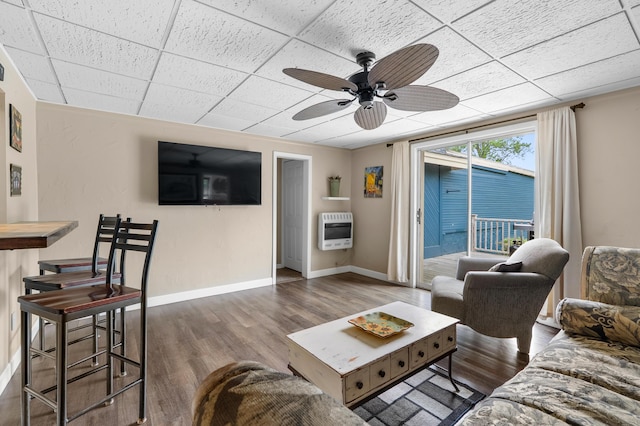 08763 Silver Lake Rd, Grand Junction, MI 49056 - living area featuring heating unit, ceiling fan, wood finished floors, baseboards, and a paneled ceiling