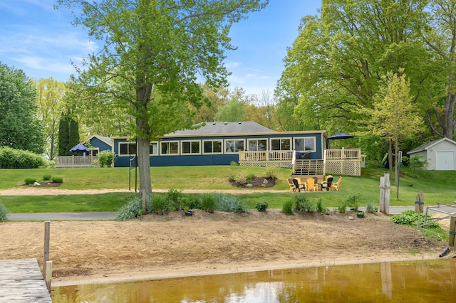 08763 Silver Lake Rd, Grand Junction, MI 49056 - rear view of house featuring a deck with water view, a yard, and a sunroom