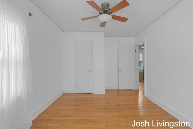 957 Breton Rd SE, Grand Rapids, MI 49506 - unfurnished bedroom featuring light wood-style floors, baseboards, and a ceiling fan