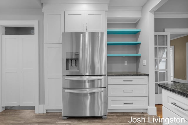 957 Breton Rd SE, Grand Rapids, MI 49506 - kitchen with stainless steel fridge with ice dispenser, crown molding, dark stone countertops, white cabinetry, and open shelves