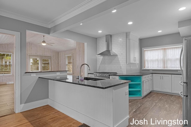 957 Breton Rd SE, Grand Rapids, MI 49506 - kitchen with wall chimney exhaust hood, a sink, healthy amount of natural light, stainless steel appliances, and ornamental molding