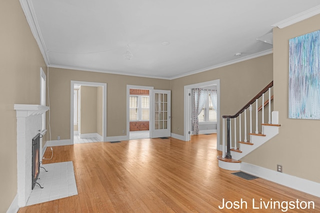 957 Breton Rd SE, Grand Rapids, MI 49506 - unfurnished living room featuring light wood-style floors, stairs, ornamental molding, and baseboards