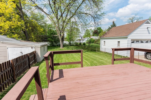 wooden deck featuring a garage and an outdoor structure