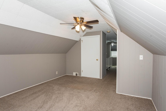 additional living space with carpet flooring, lofted ceiling, and a ceiling fan