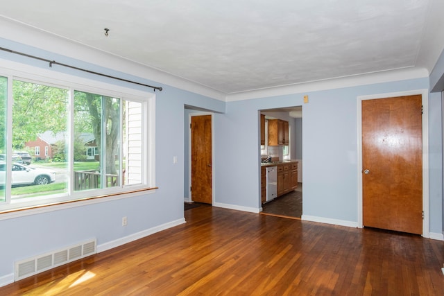 unfurnished room with dark wood-type flooring, baseboards, and a sink