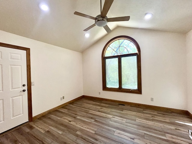 unfurnished room featuring ceiling fan, lofted ceiling, wood finished floors, recessed lighting, and baseboards