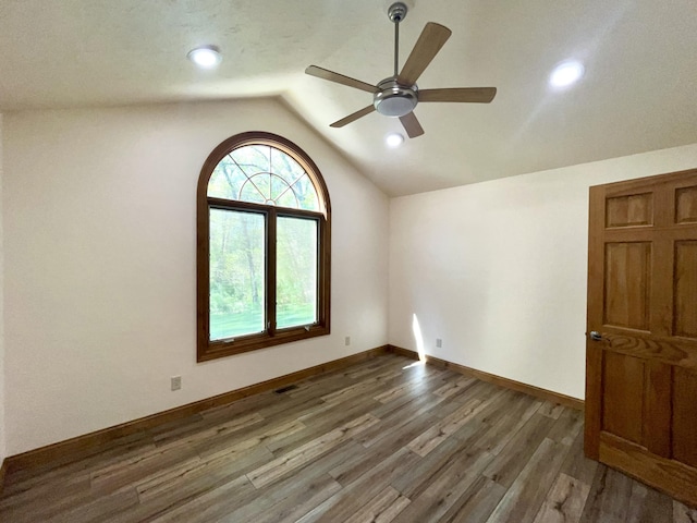spare room with vaulted ceiling, a ceiling fan, wood finished floors, recessed lighting, and baseboards