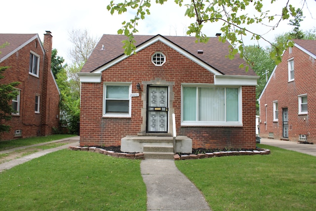 20091 Bentler St, Detroit, MI 48219 - bungalow-style home with brick siding, a shingled roof, and a front lawn