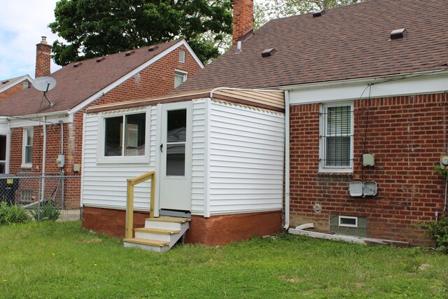 20091 Bentler St, Detroit, MI 48219 - rear view of property with entry steps, brick siding, a chimney, and roof with shingles