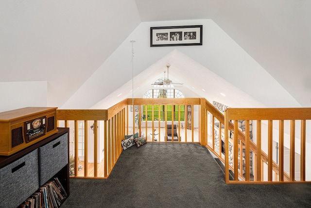 corridor with lofted ceiling and carpet floors