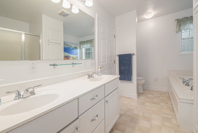 bathroom featuring toilet, double vanity, a bath, a shower stall, and baseboards