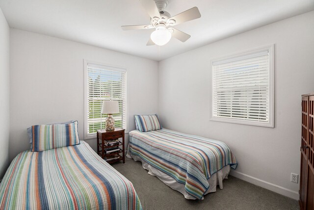 carpeted bedroom with baseboards and ceiling fan