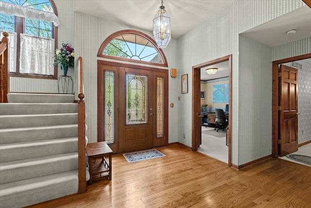46890 Cider Mill Dr, Novi, MI 48374 - entryway with light wood-style floors, wallpapered walls, plenty of natural light, stairs, and a chandelier