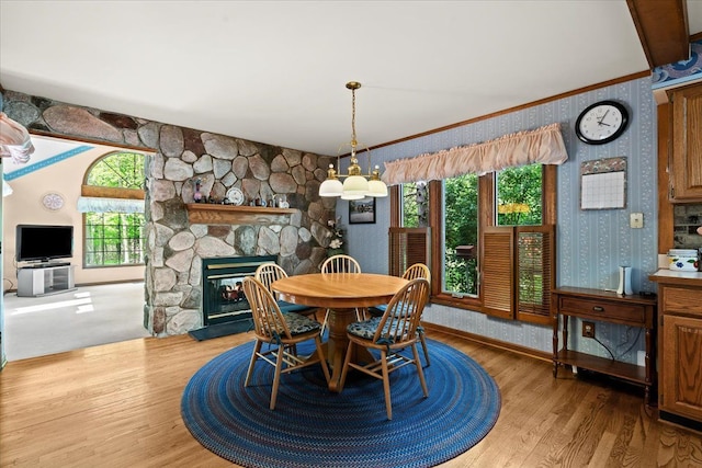 46890 Cider Mill Dr, Novi, MI 48374 - dining area with wallpapered walls, wood finished floors, crown molding, a fireplace, and baseboards
