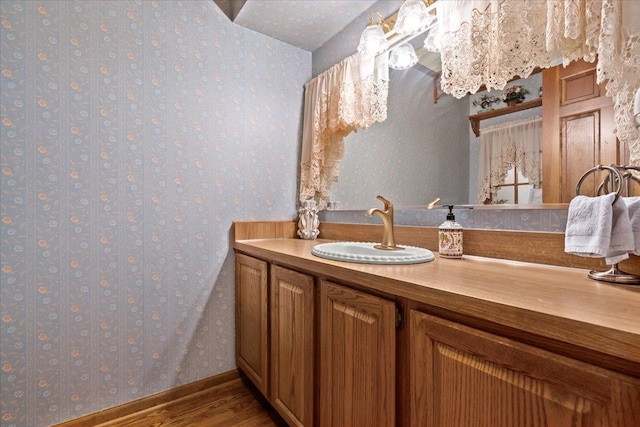 46890 Cider Mill Dr, Novi, MI 48374 - bathroom with wallpapered walls, wood finished floors, and vanity