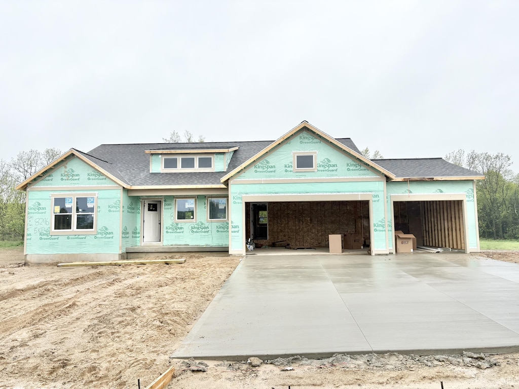 8296 Kettle Oak Dr SE, Alto, MI 49302 - unfinished property with a garage, concrete driveway, and a shingled roof