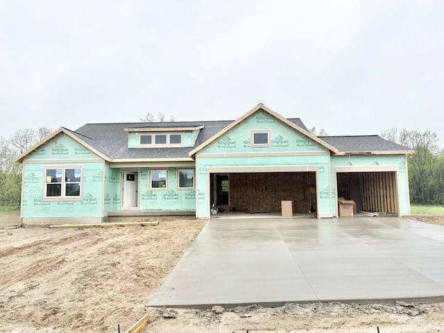 8296 Kettle Oak Dr SE, Alto, MI 49302 - unfinished property with a garage, concrete driveway, and a shingled roof