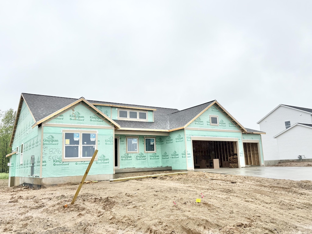 8296 Kettle Oak Dr SE, Alto, MI 49302 - property in mid-construction with roof with shingles, a garage, and concrete driveway