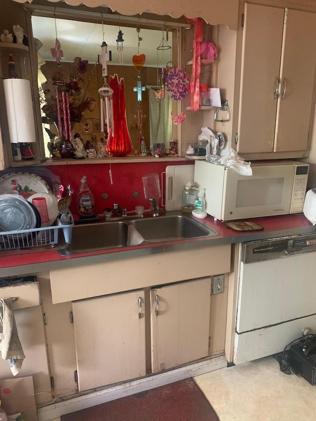 kitchen with white appliances and a sink