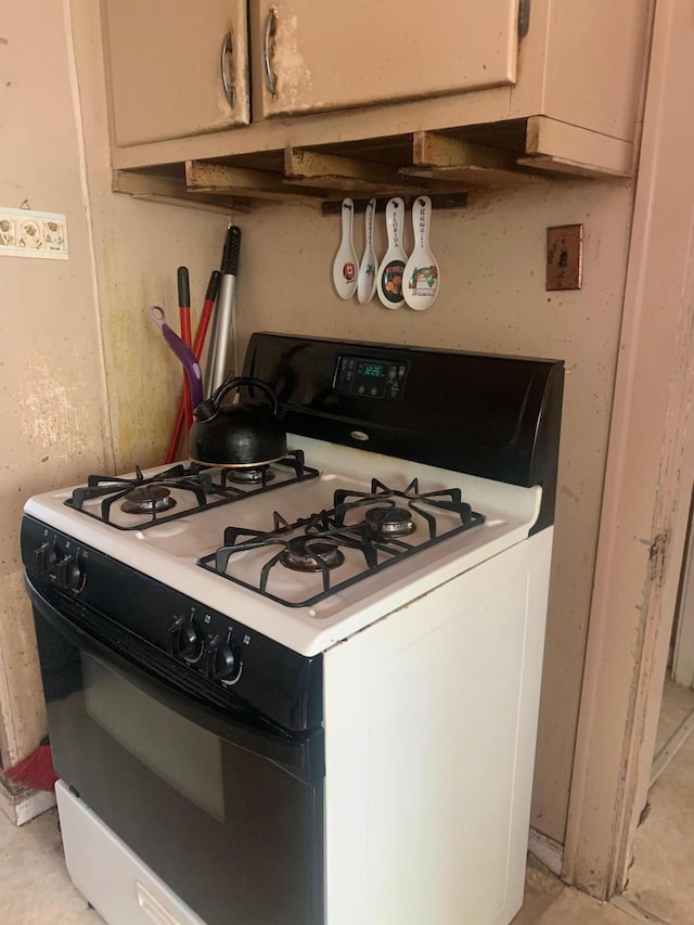 kitchen featuring gas stove and light countertops