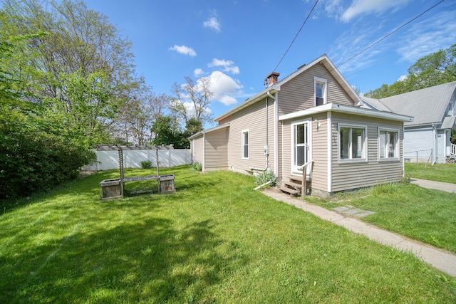 1702 Teneyck St, Jackson, MI 49203 - rear view of house with entry steps and a chimney
