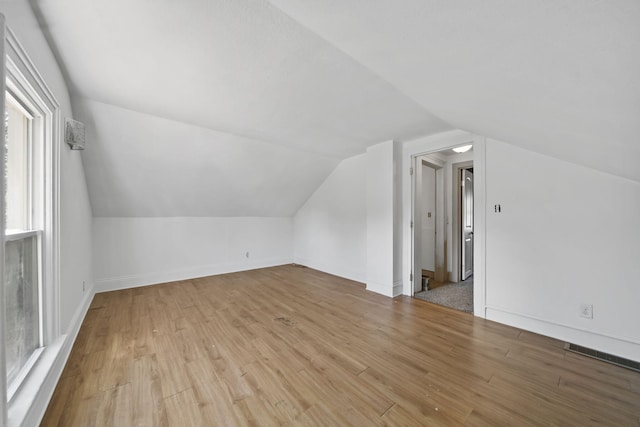 1702 Teneyck St, Jackson, MI 49203 - bonus room featuring vaulted ceiling, wood finished floors, and baseboards