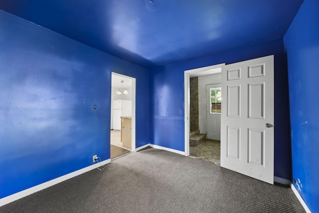 1702 Teneyck St, Jackson, MI 49203 - unfurnished bedroom featuring freestanding refrigerator, carpet, and baseboards