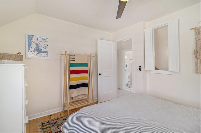 371 4th St, Pentwater, MI 49449 - bedroom featuring wood finished floors, vaulted ceiling, ceiling fan, and baseboards