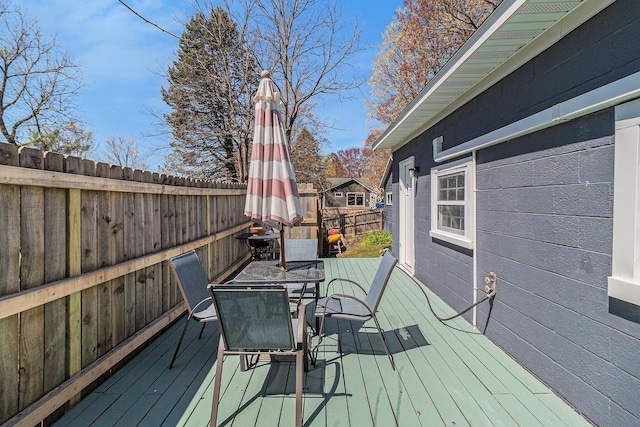 371 4th St, Pentwater, MI 49449 - wooden deck with fence and outdoor dining area