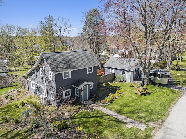 371 4th St, Pentwater, MI 49449 - view of front of home featuring a shingled roof and an outbuilding