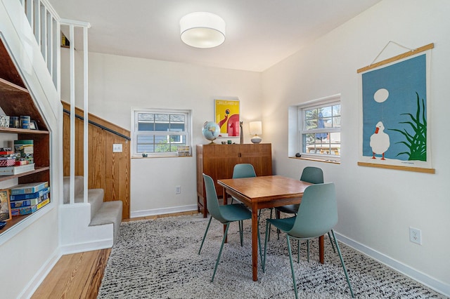 371 4th St, Pentwater, MI 49449 - dining area featuring stairway, baseboards, and wood finished floors