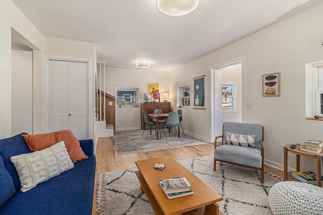 371 4th St, Pentwater, MI 49449 - living area featuring stairway, wood finished floors, and baseboards