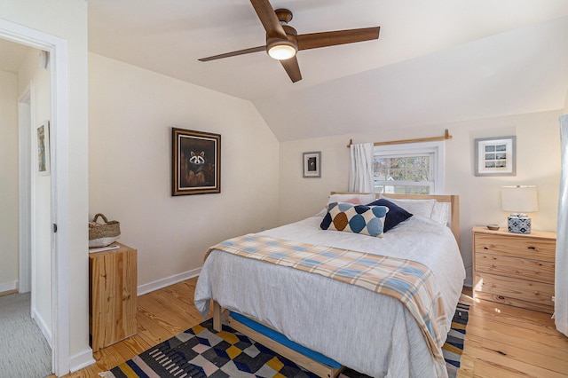 371 4th St, Pentwater, MI 49449 - bedroom featuring light wood-style floors, vaulted ceiling, baseboards, and ceiling fan
