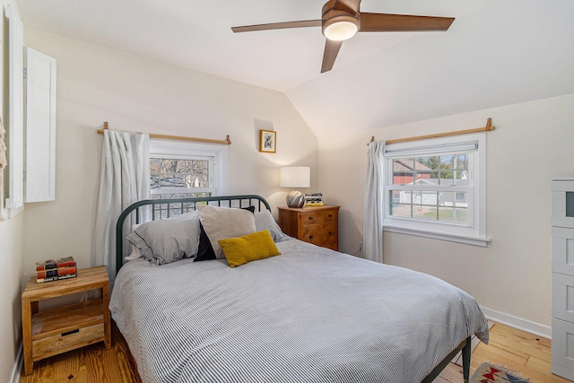 371 4th St, Pentwater, MI 49449 - bedroom with light wood-style flooring, lofted ceiling, baseboards, and a ceiling fan