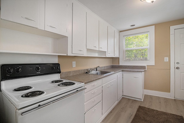 2335 Holmes Rd, Ypsilanti, MI 48198 - kitchen with white electric range oven, a sink, light wood finished floors, and white cabinetry