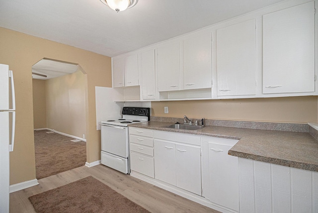 2335 Holmes Rd, Ypsilanti, MI 48198 - kitchen featuring white appliances, arched walkways, light wood-style flooring, white cabinets, and a sink